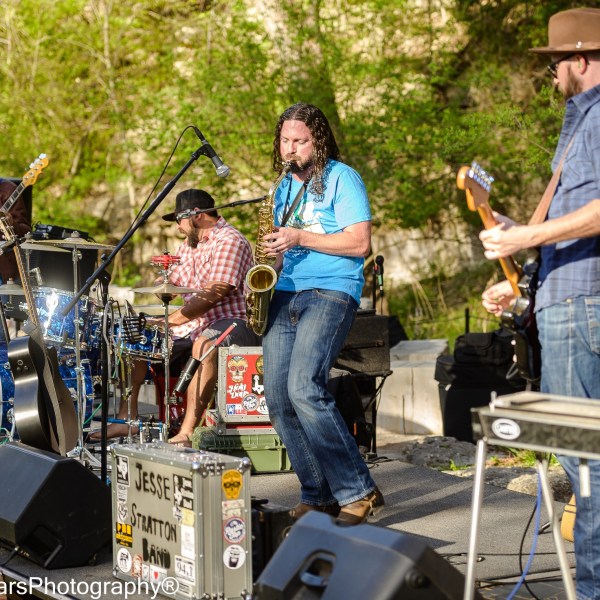 a group of people standing around a motorcycle
