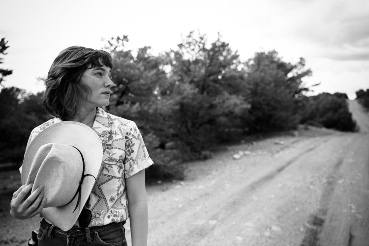 351567126_559898443012964_1544377995077257710_n a person standing next to a road