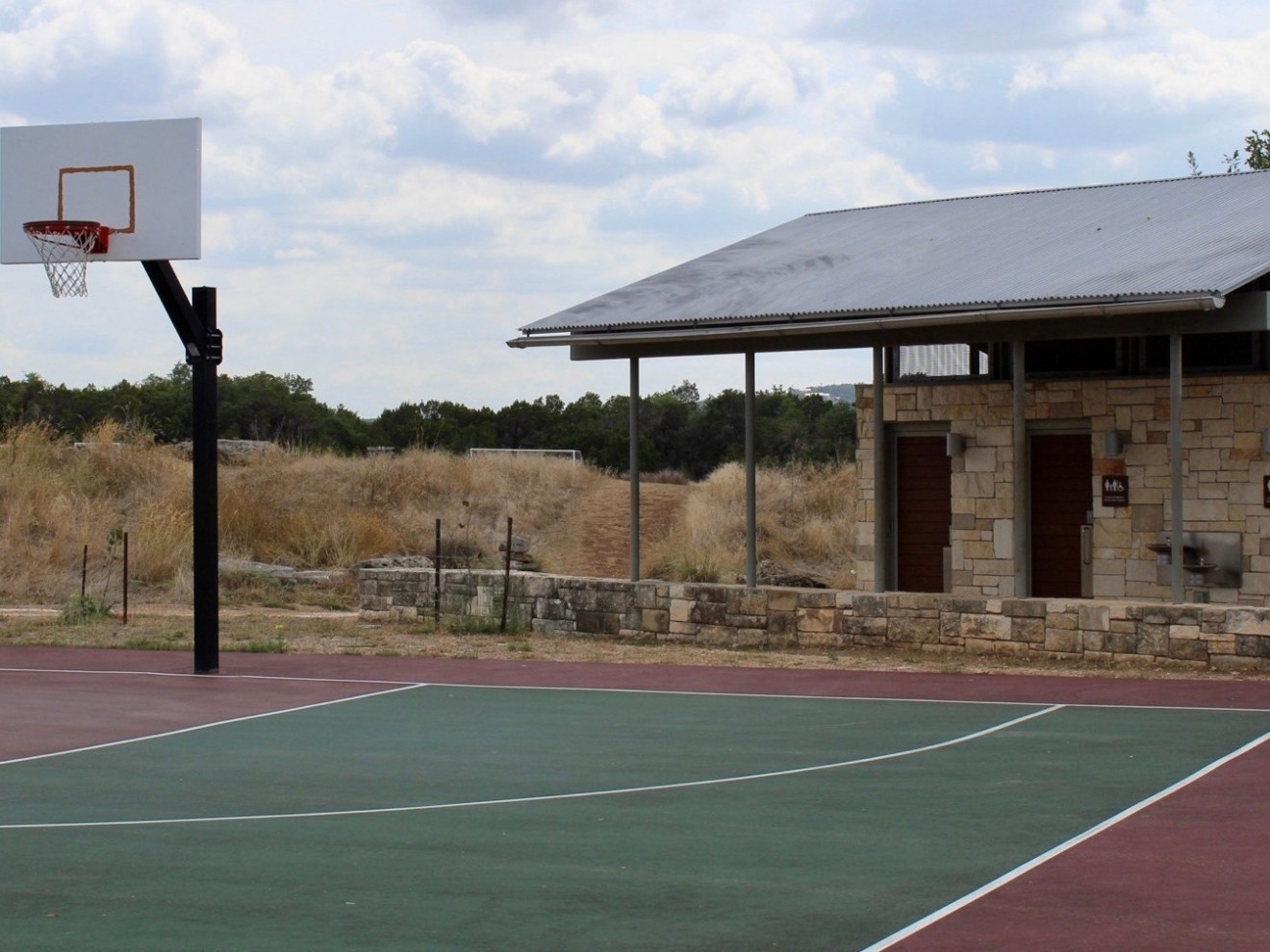 a building with a basketball on a court with a racket