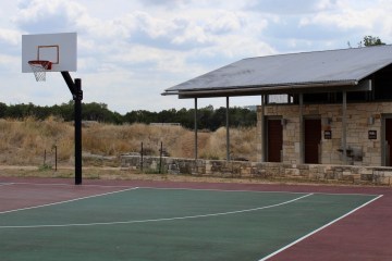 a building with a basketball on a court with a racket
