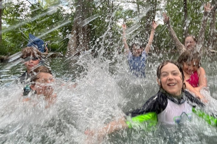 a group of people playing in the water