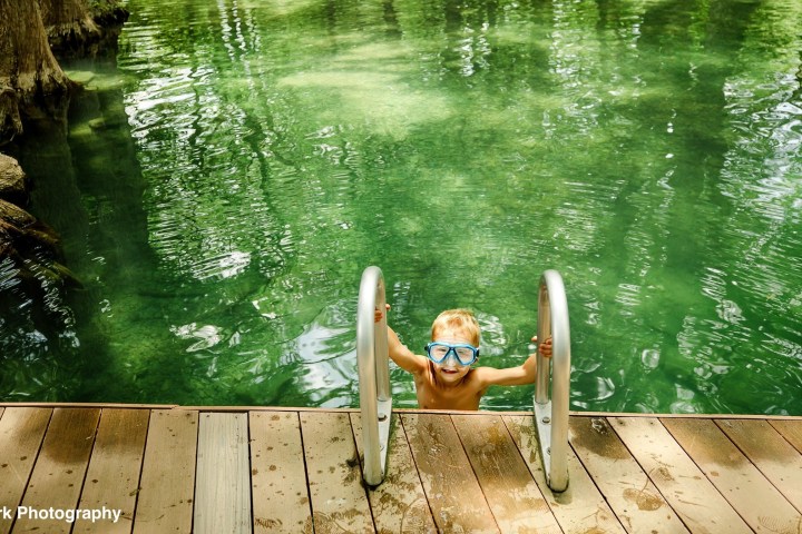 a wooden bench sitting in the water