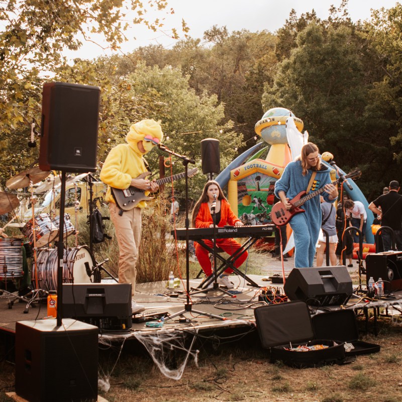 a group of people standing in a parking lot