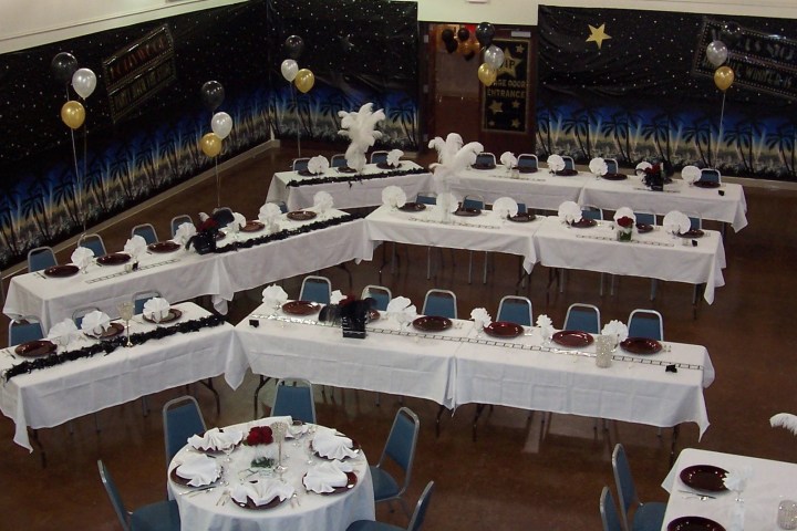 a bunch of people sitting at a table in front of a mirror