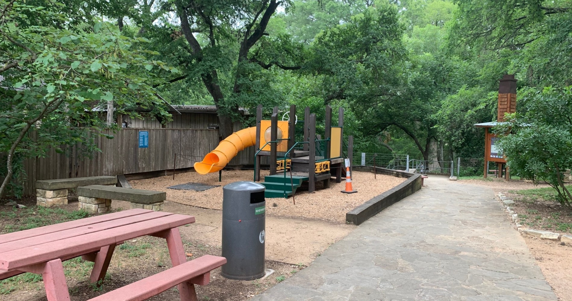 a person sitting on a bench in a park