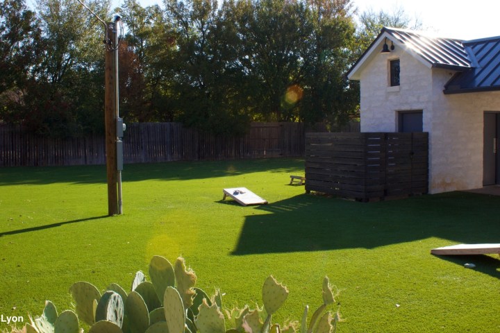 a group of lawn chairs sitting on top of a grass covered field