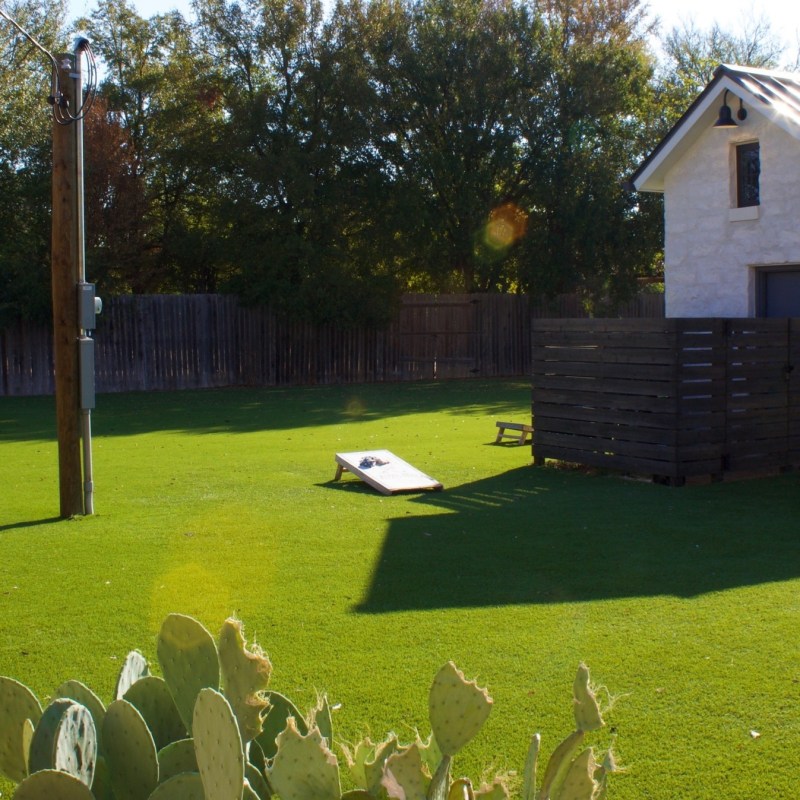 a group of lawn chairs sitting on top of a grass covered field