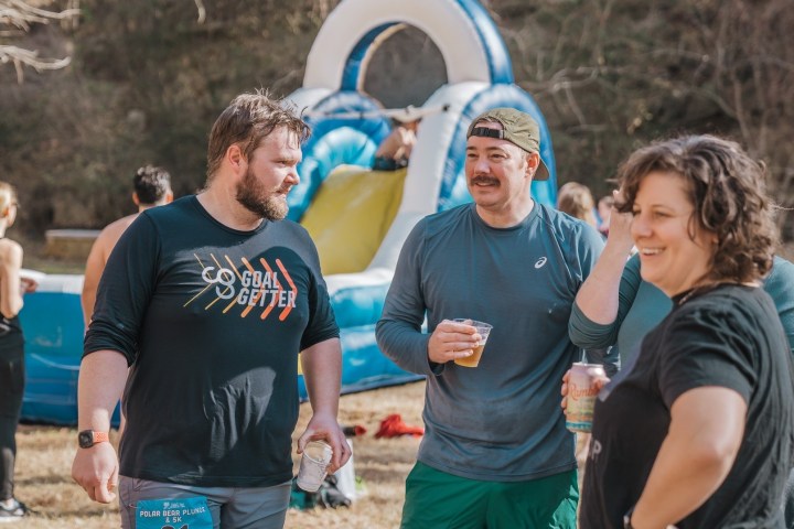 a couple of people that are standing in the grass