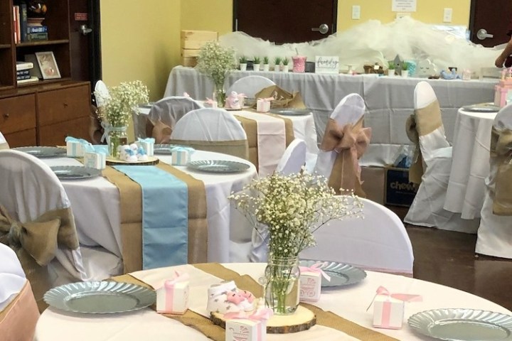 a person sitting at a table with a cake