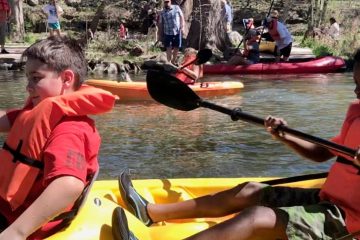 a group of people on a boat in the water