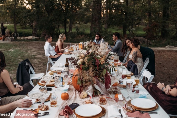 a group of people sitting at a table eating food