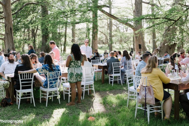 a group of people sitting at a picnic table