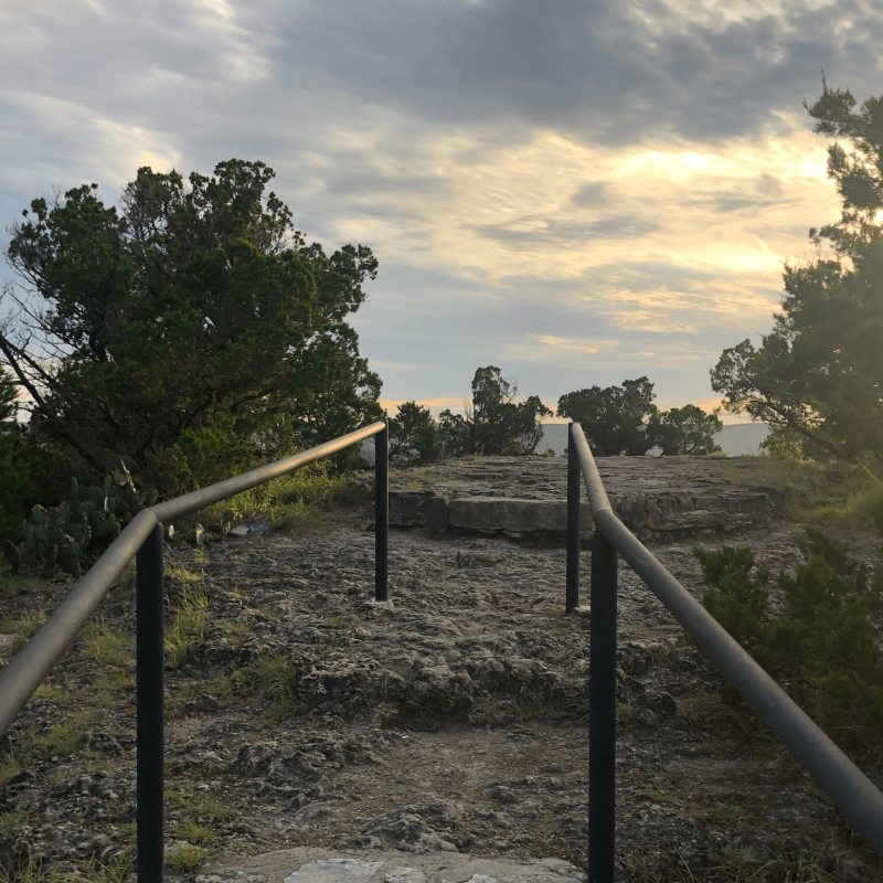 a pole that has a sign on a fence