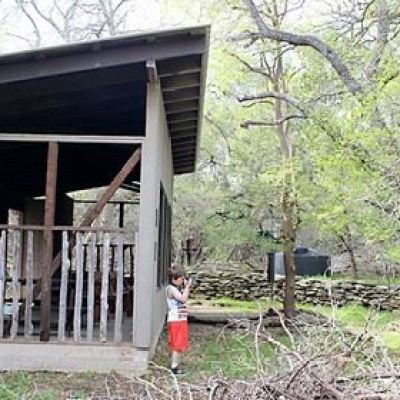 a group of people standing in front of a fence