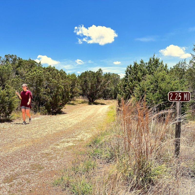 a sign on a dirt road