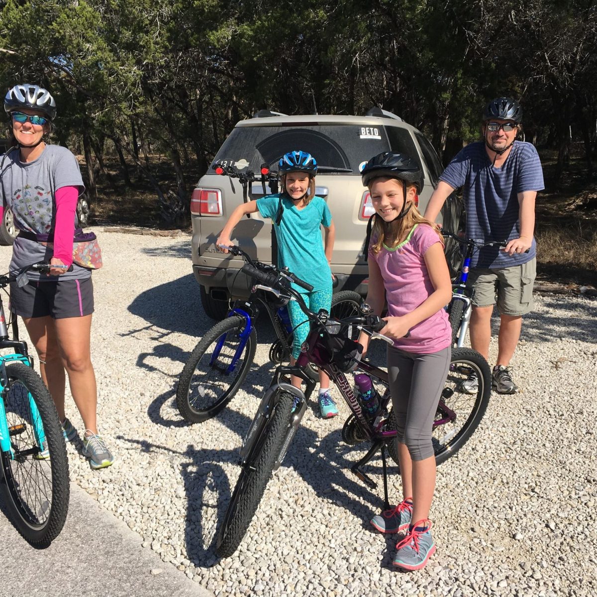 a group of people riding on the back of a bicycle