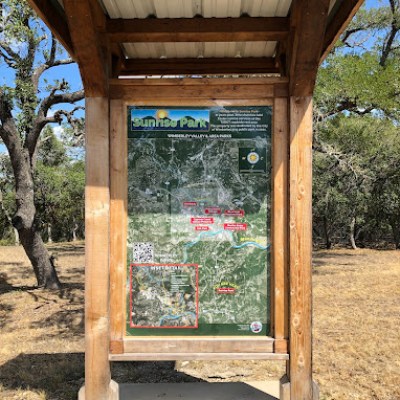a wooden statue in a park