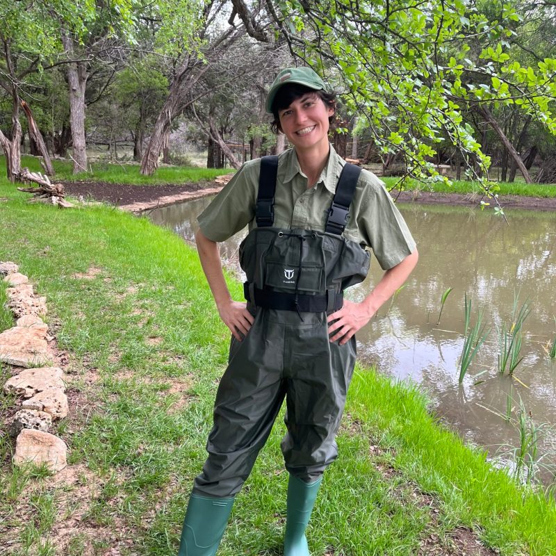 a man standing next to a tree