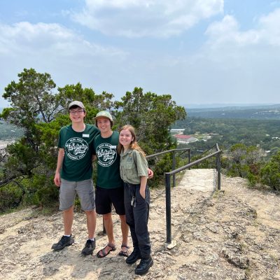 a man standing next to a body of water