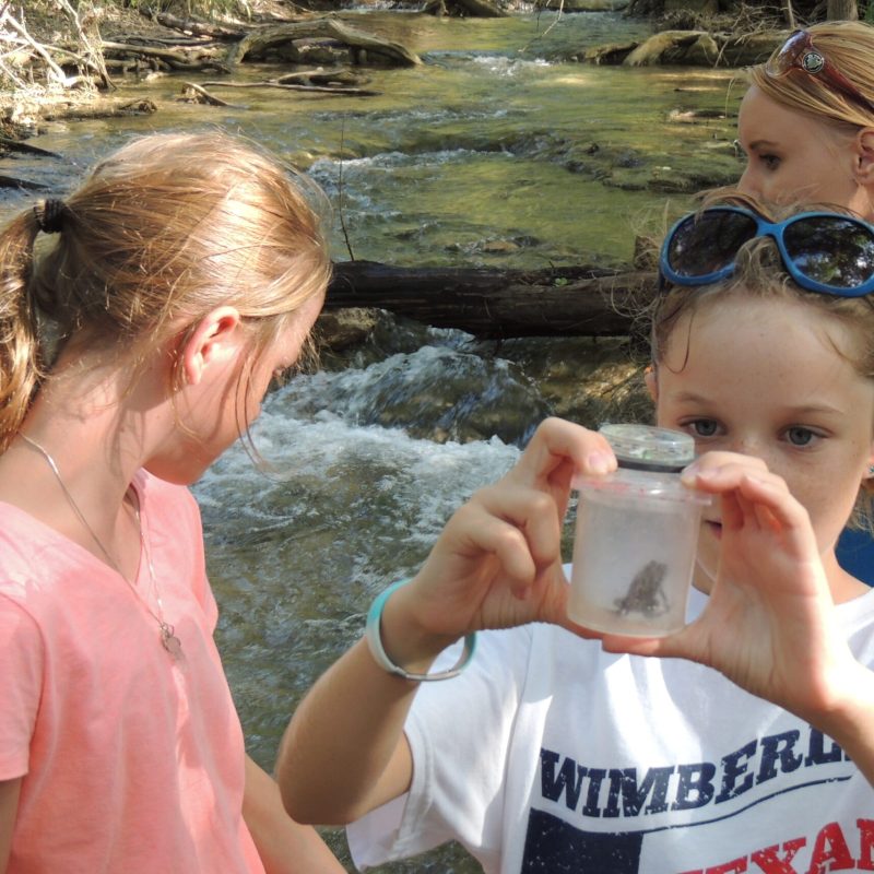a woman drinking a glass of water