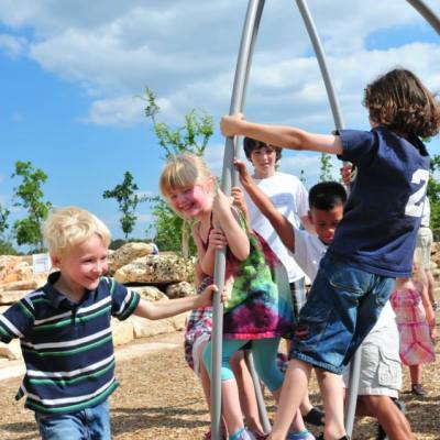 a little boy that is standing in the dirt