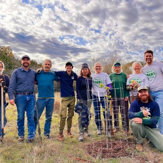 a group of people standing in a field