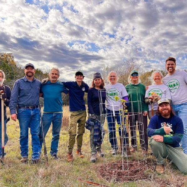a group of people standing in a field