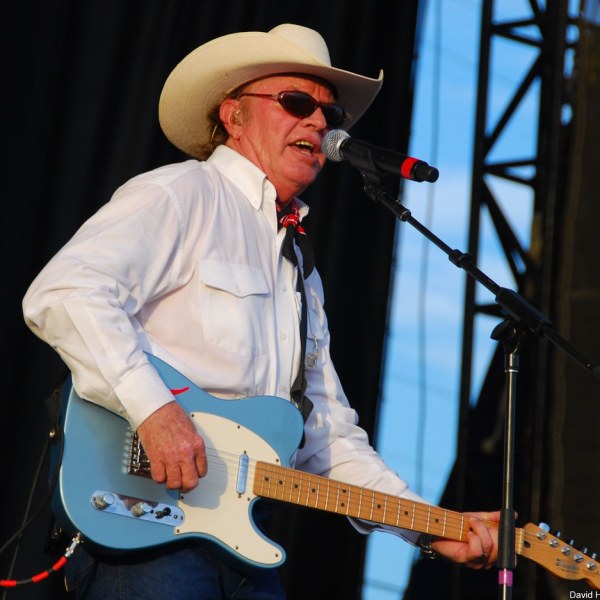 Gary P. Nunn wearing a hat and holding a guitar