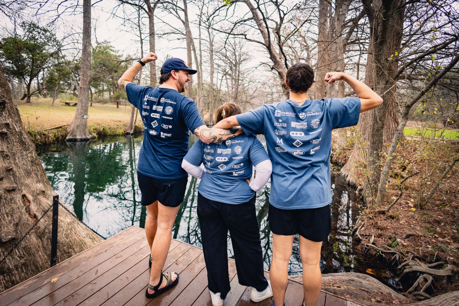 a man and a woman standing next to a tree