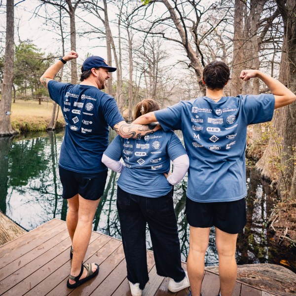 a man and a woman standing next to a tree