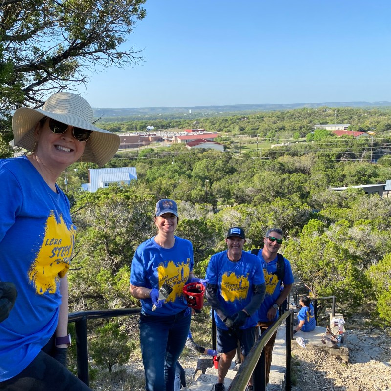 a group of people that are standing in the grass