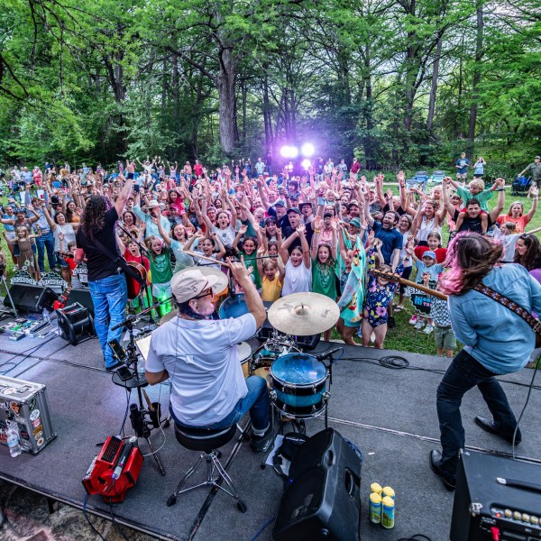 a group of people riding on the back of a motorcycle