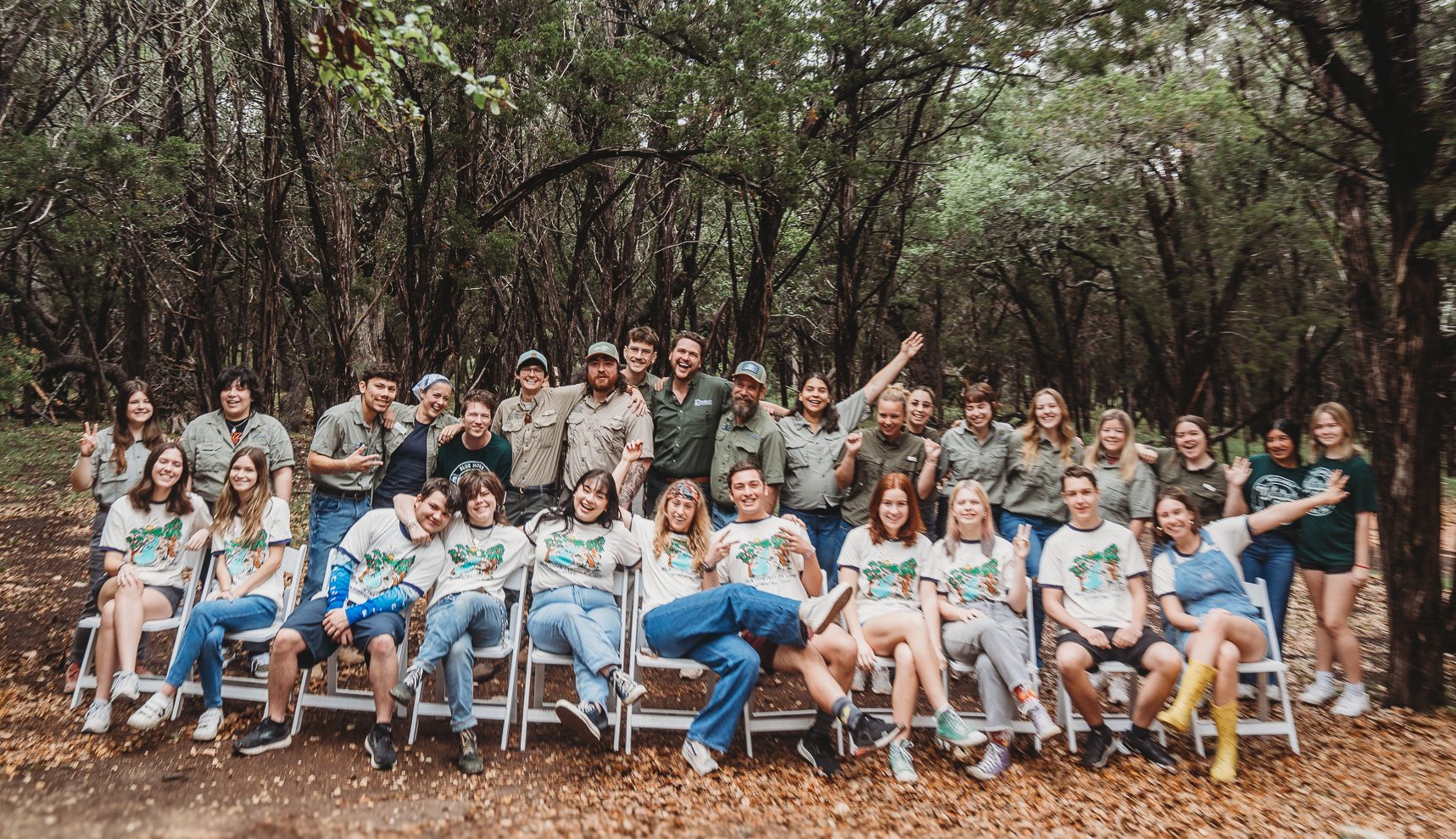 a group of people in front of a crowd of people at a park
